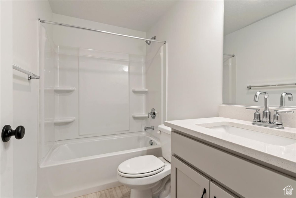 Full bathroom featuring shower / tub combination, toilet, and vanity