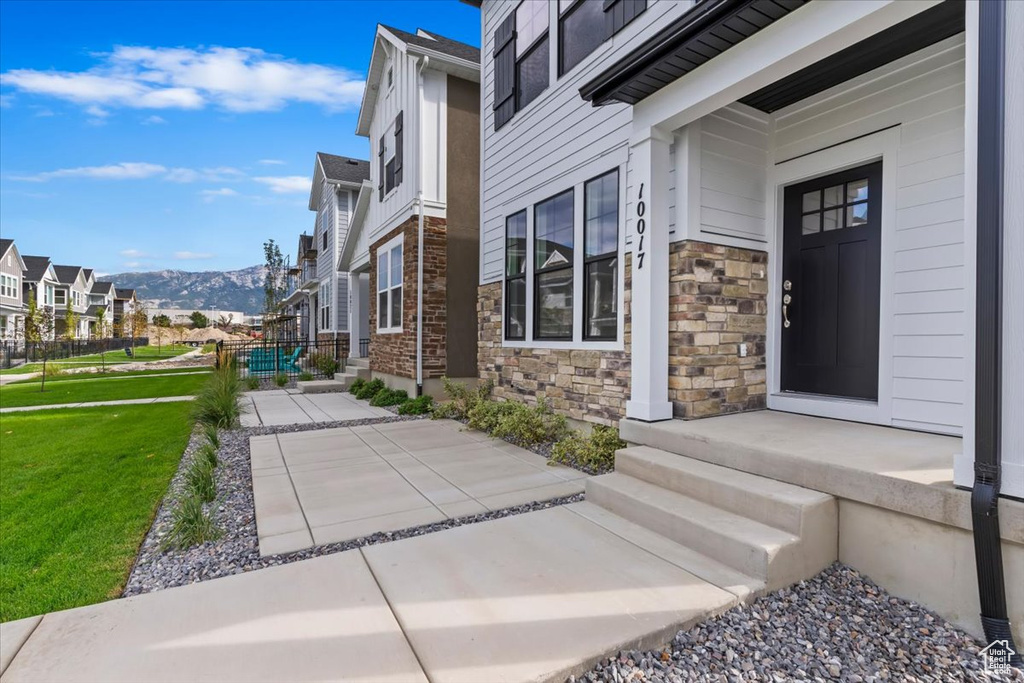 View of home's exterior featuring a mountain view and a lawn