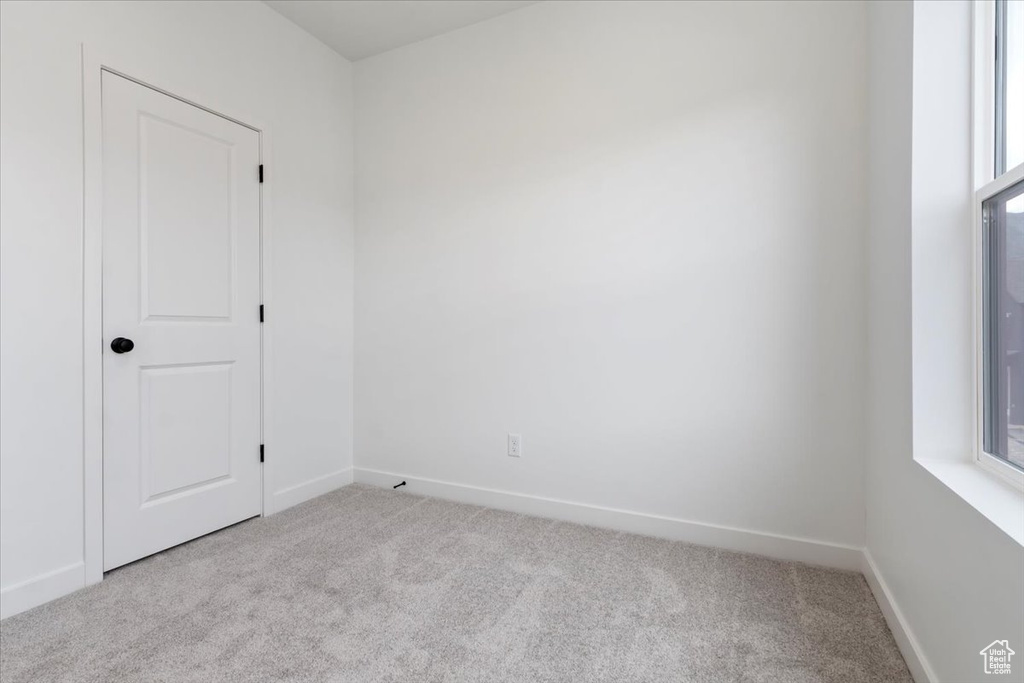 Empty room with light colored carpet