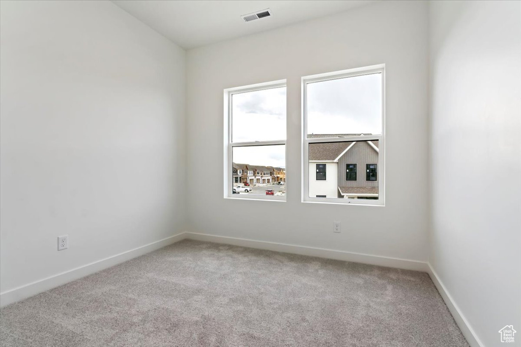 Unfurnished room featuring light colored carpet