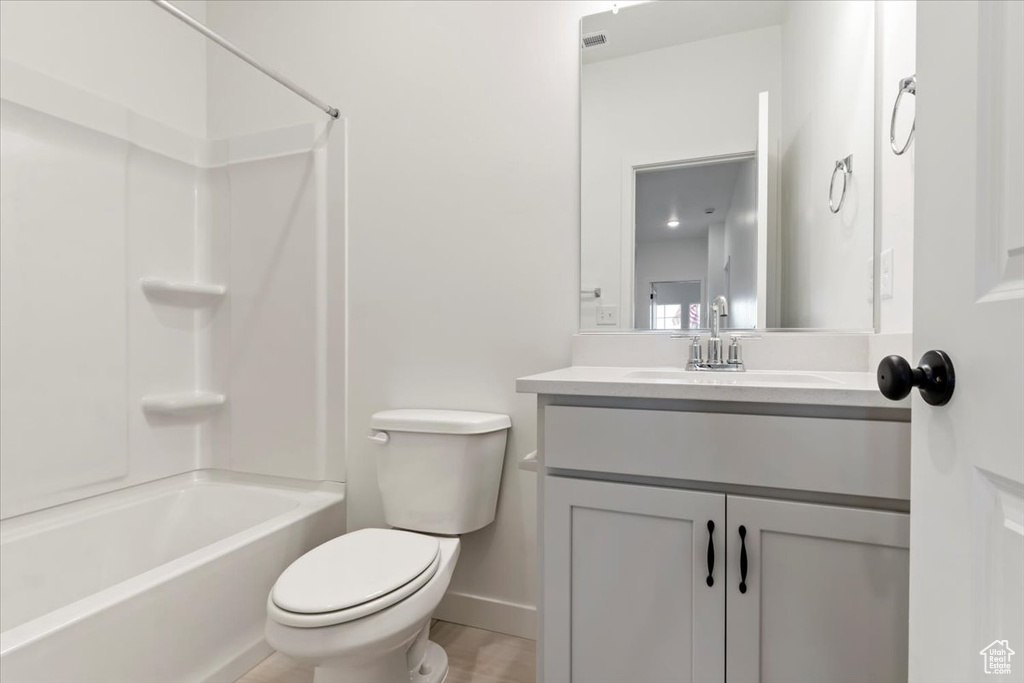 Full bathroom featuring vanity, toilet, and bathtub / shower combination