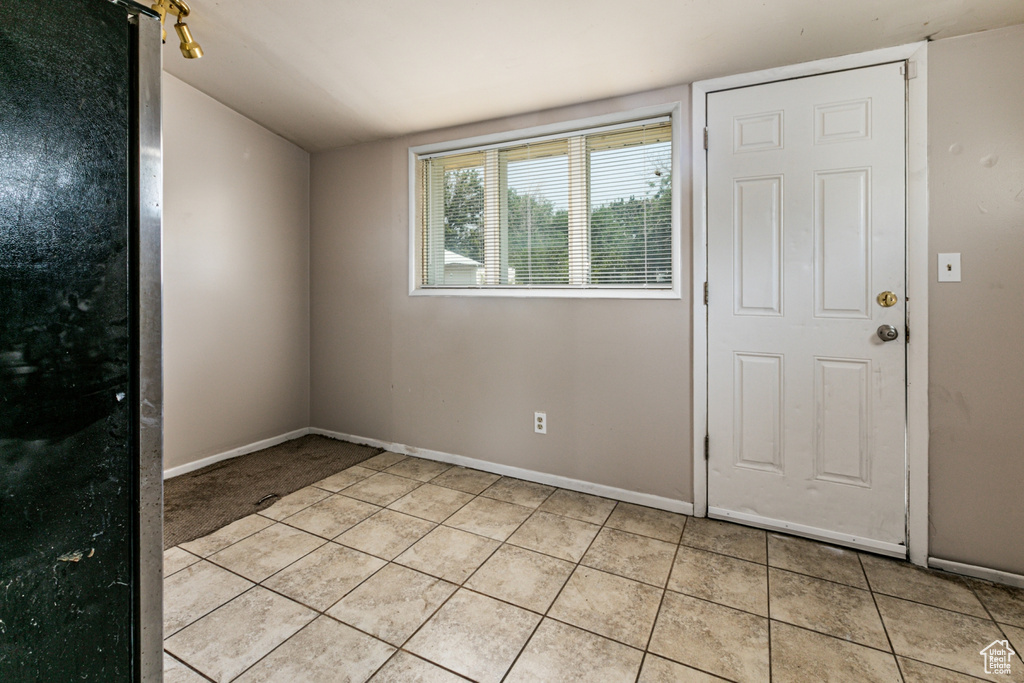 Entrance foyer with light tile patterned floors