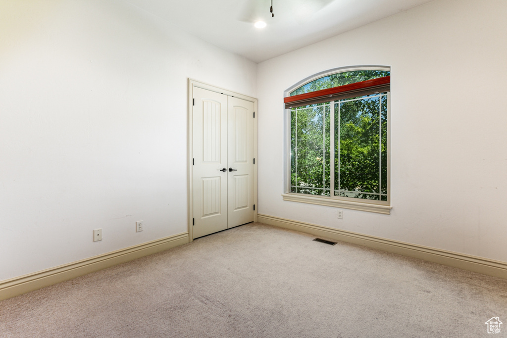 Spare room with light colored carpet