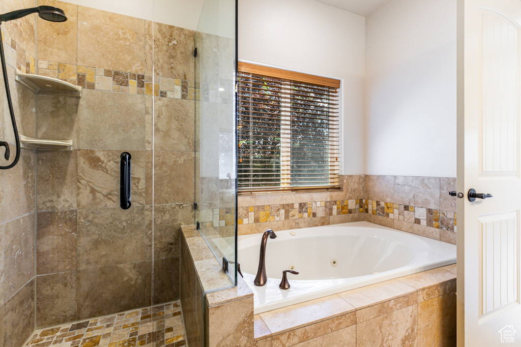 Bathroom featuring shower with separate bathtub