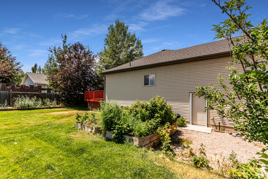 View of property exterior with a lawn