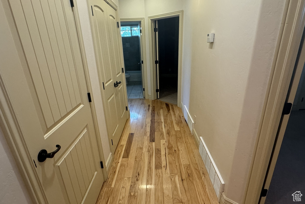 Corridor with light wood-type flooring