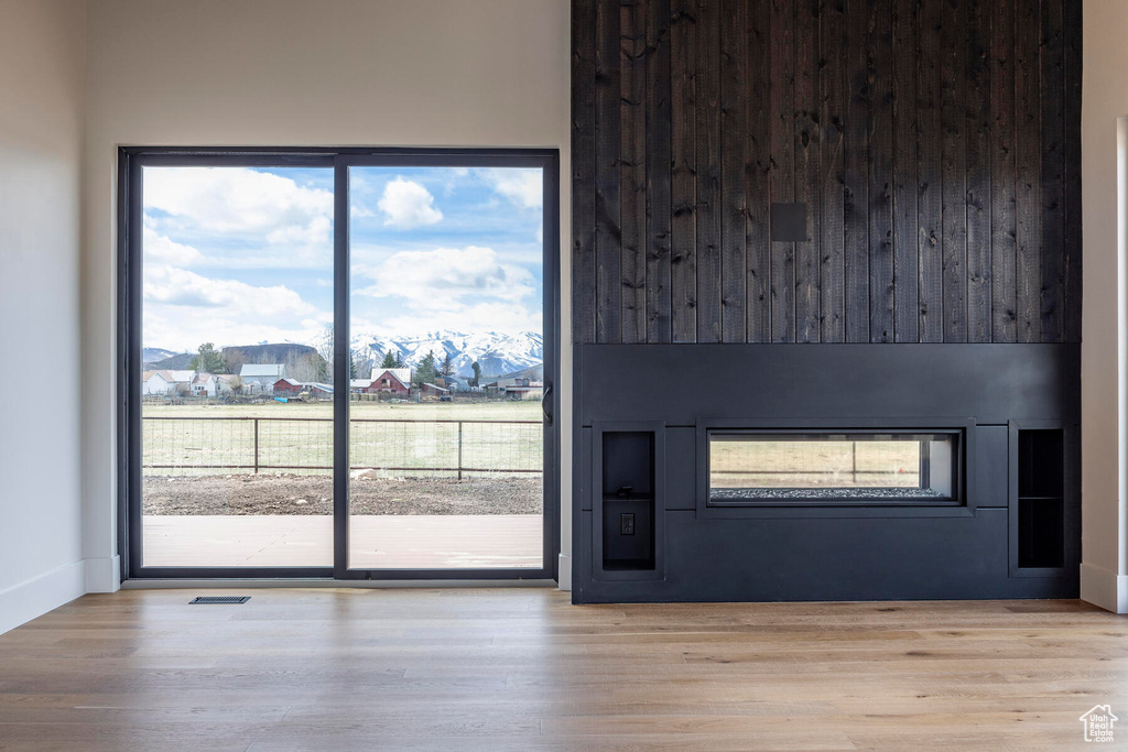 Interior space featuring a fireplace, a healthy amount of sunlight, and light wood-type flooring