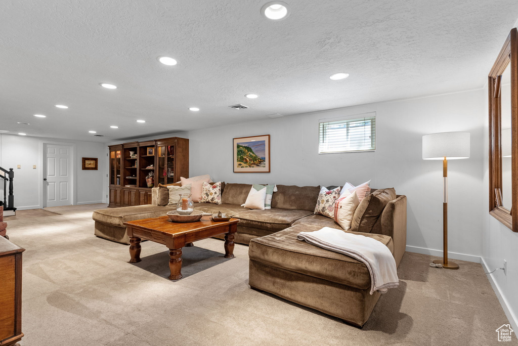 Living room featuring a textured ceiling and light colored carpet