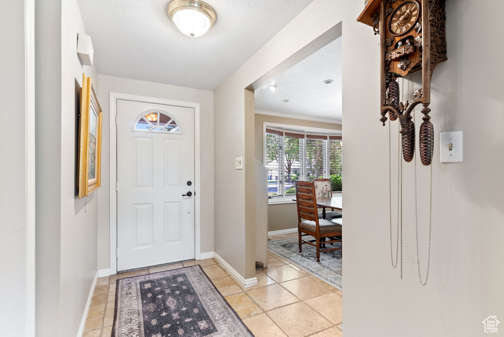 Tiled foyer with ornamental molding