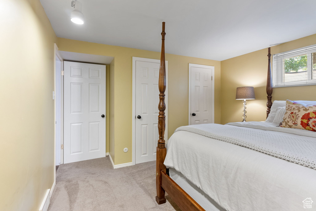 Bedroom featuring light colored carpet