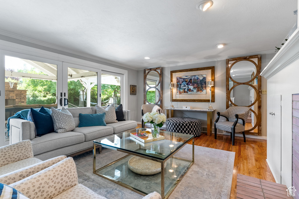 Living room featuring light hardwood / wood-style flooring and ornamental molding