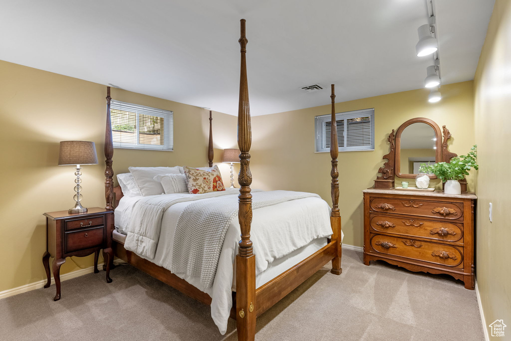 Carpeted bedroom with track lighting