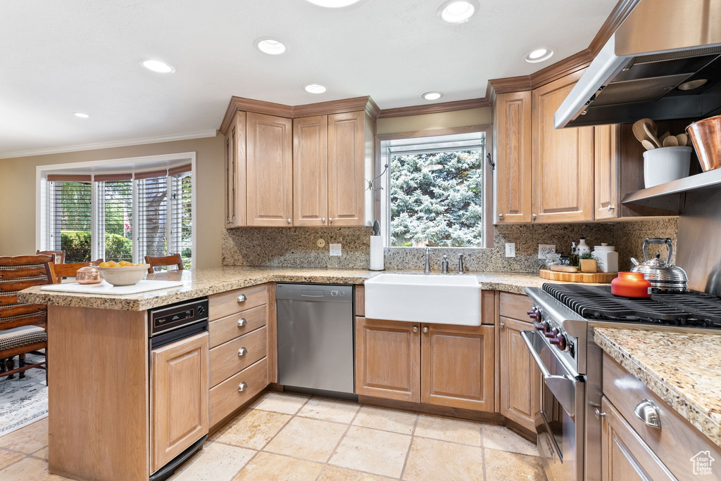 Kitchen with kitchen peninsula, backsplash, and stainless steel appliances