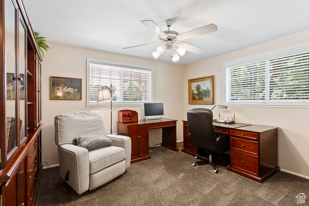 Home office with light carpet and ceiling fan