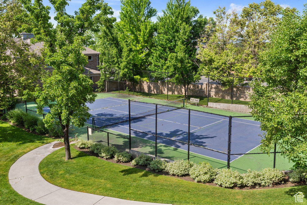 View of tennis court featuring a lawn