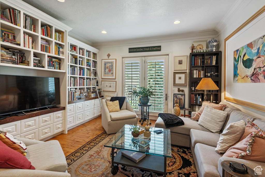 Living room featuring light hardwood / wood-style flooring and crown molding