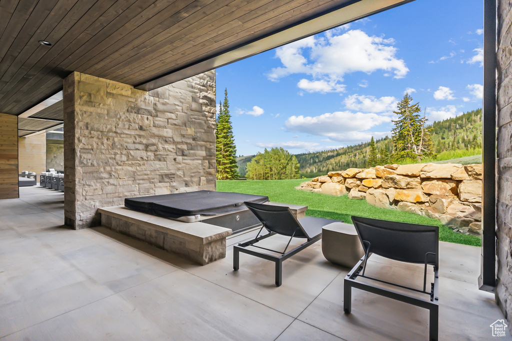 View of patio with a covered hot tub