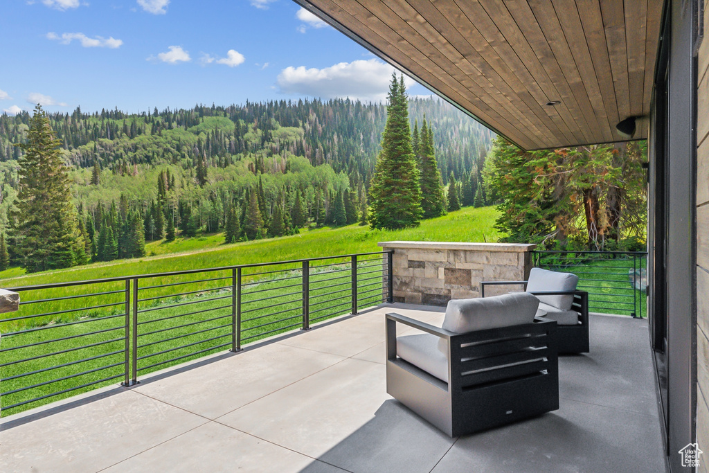 View of patio with a balcony