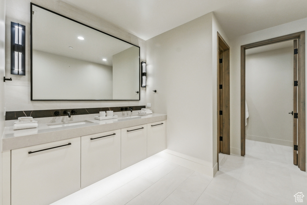 Bathroom with tile patterned flooring and double sink vanity