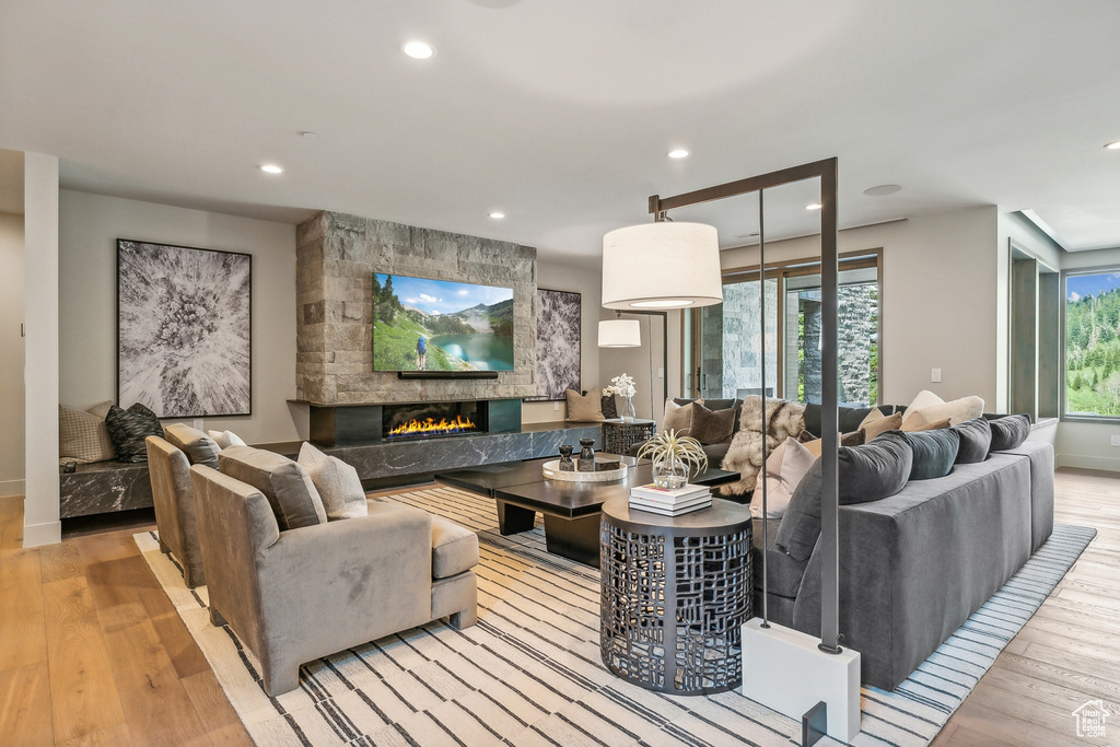 Living room with a fireplace and light hardwood / wood-style floors