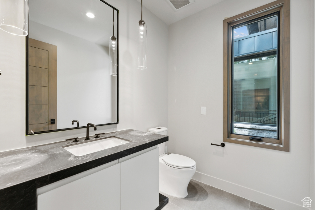 Bathroom with tile patterned flooring, toilet, and vanity