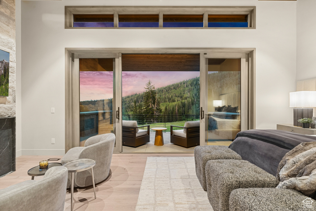 Living room with light hardwood / wood-style flooring and a healthy amount of sunlight