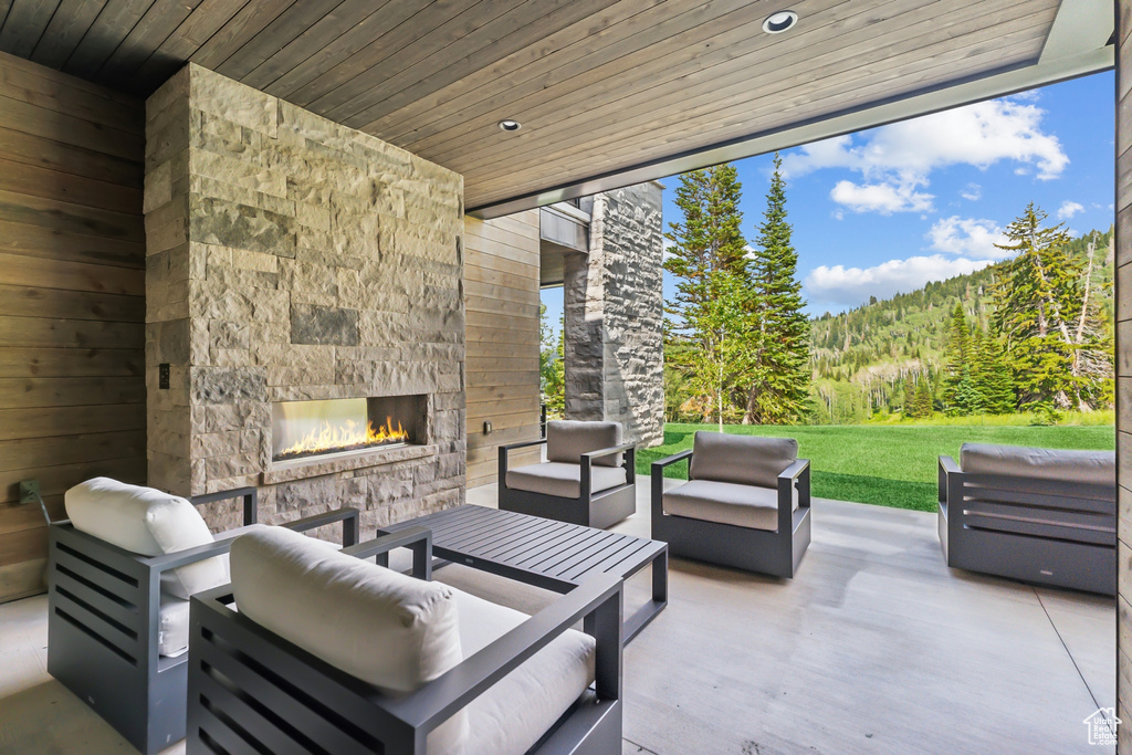 View of patio / terrace with an outdoor living space with a fireplace