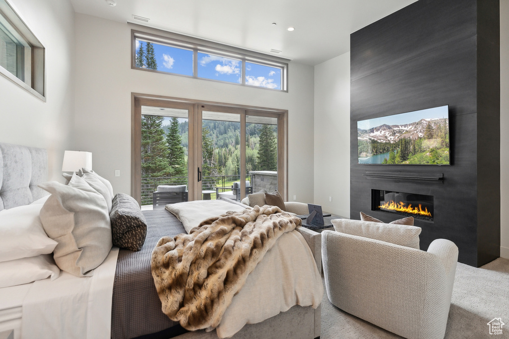 Bedroom with access to outside and a towering ceiling