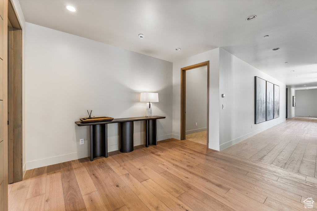 Empty room with light hardwood / wood-style floors