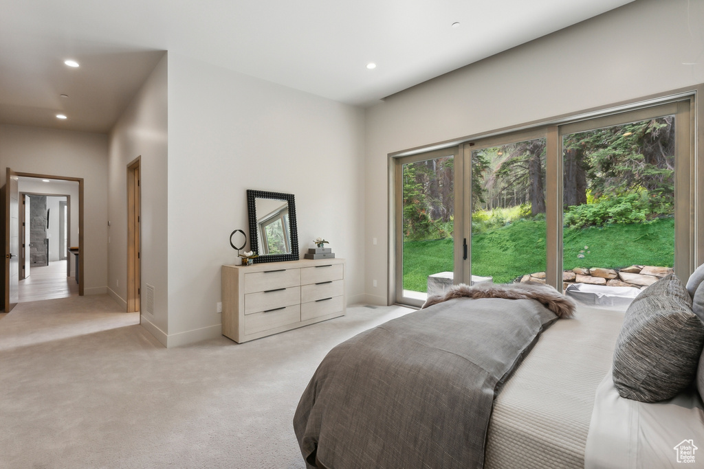 Bedroom featuring light carpet and access to outside