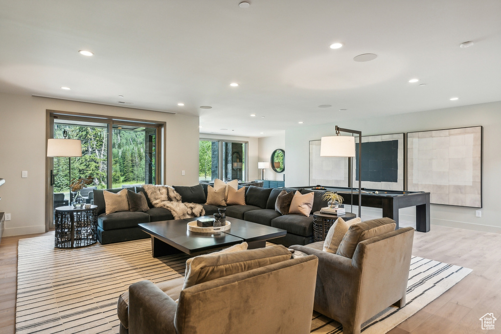 Living room featuring plenty of natural light and light hardwood / wood-style flooring