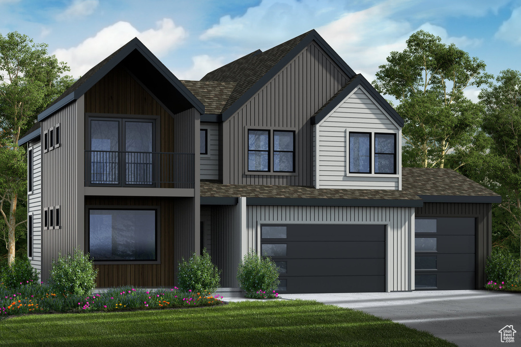 View of front facade featuring a garage and a front lawn