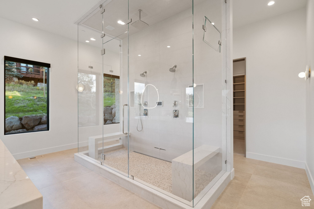 Bathroom with an enclosed shower and tile patterned floors