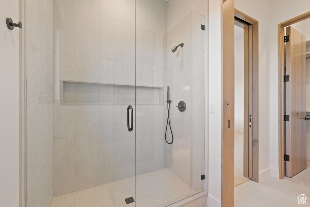 Bathroom featuring tile patterned flooring and an enclosed shower