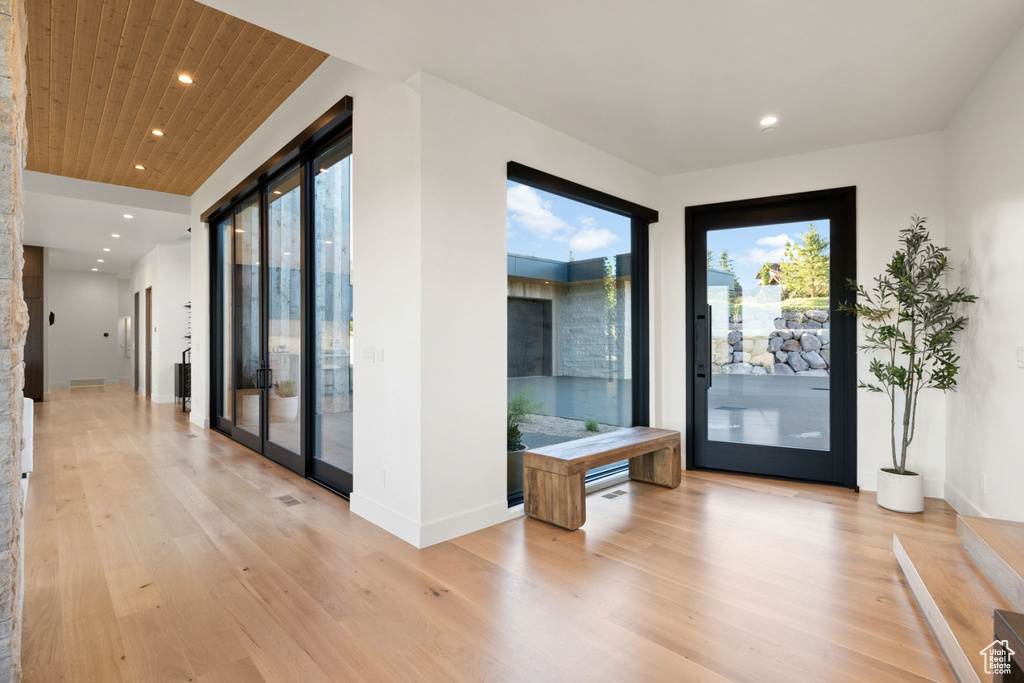 Doorway to outside with french doors, light hardwood / wood-style floors, and wood ceiling