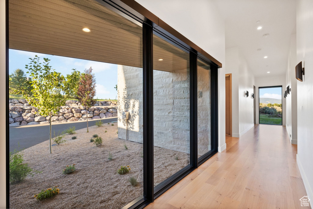 Hall with light hardwood / wood-style flooring