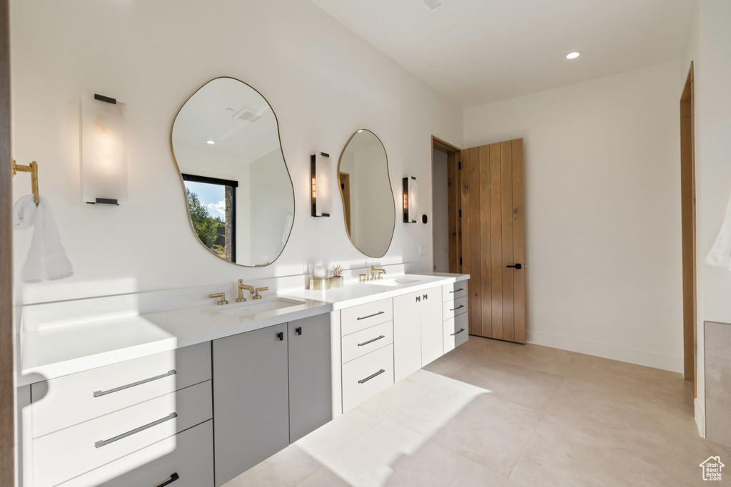 Bathroom featuring tile patterned flooring and vanity