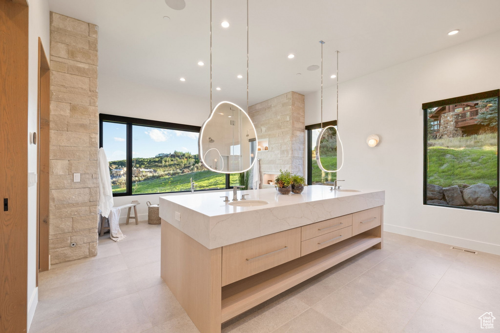 Bathroom with tile patterned flooring and vanity