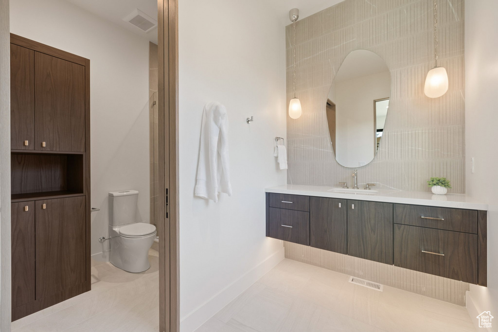 Bathroom featuring tile patterned floors, vanity, and toilet