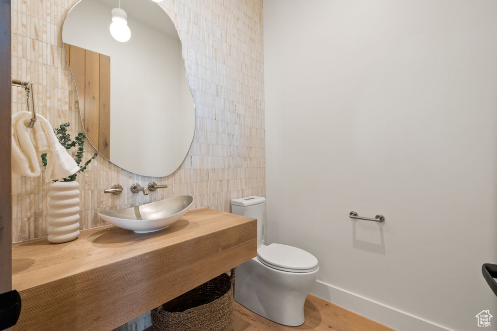 Bathroom with tile walls, toilet, and vanity