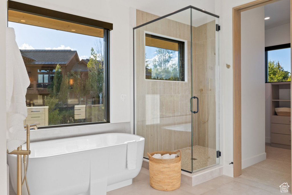 Bathroom featuring plus walk in shower and tile patterned floors