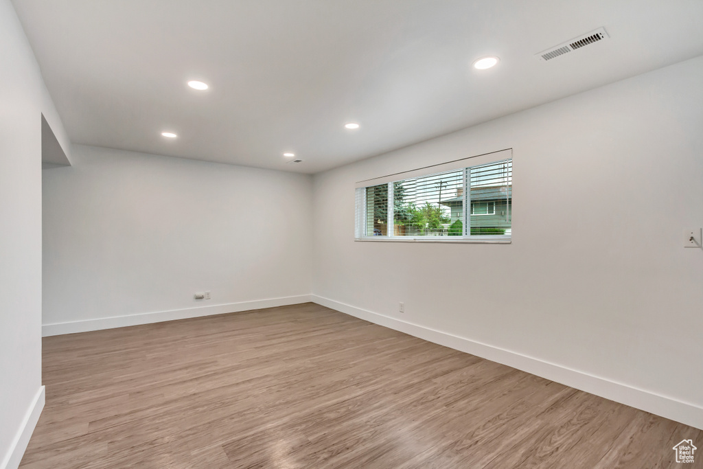 Empty room with light hardwood / wood-style floors