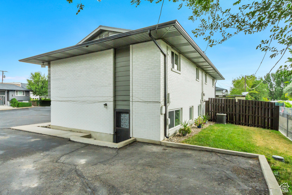 View of side of property featuring a patio and a yard