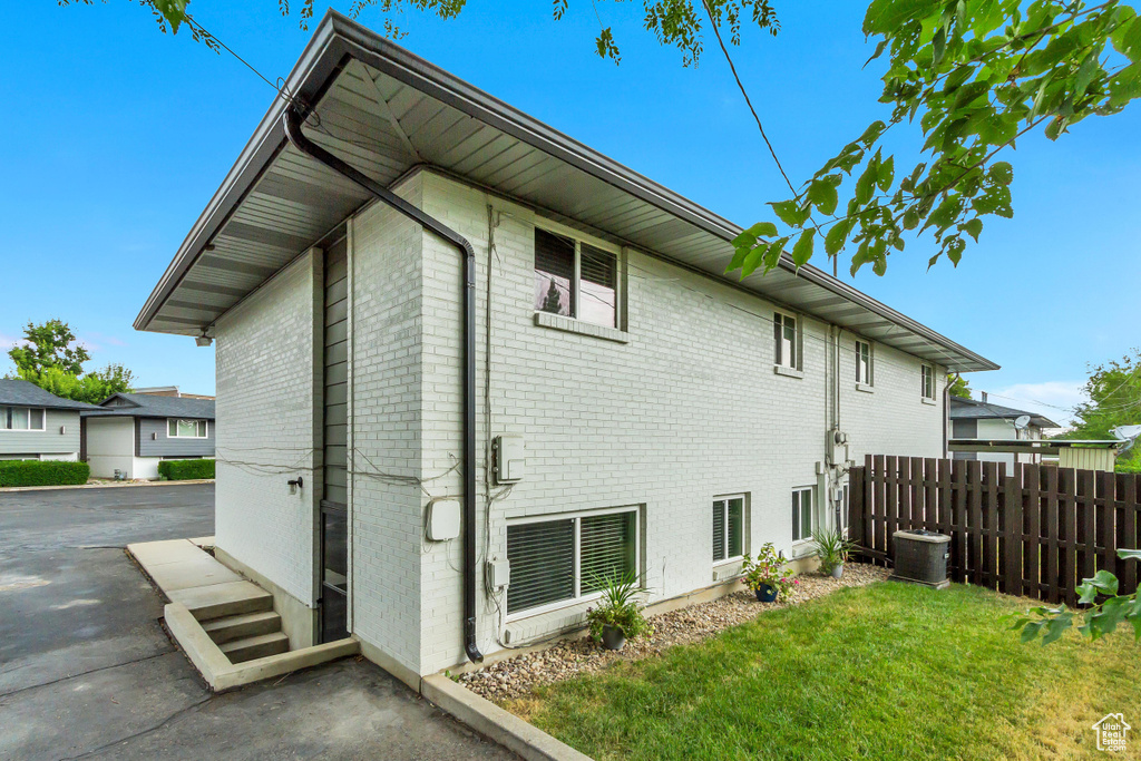 View of side of home featuring central air condition unit