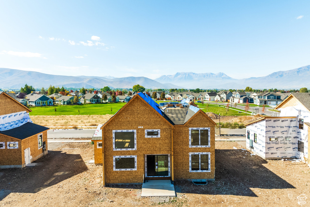 Back of property with a mountain view