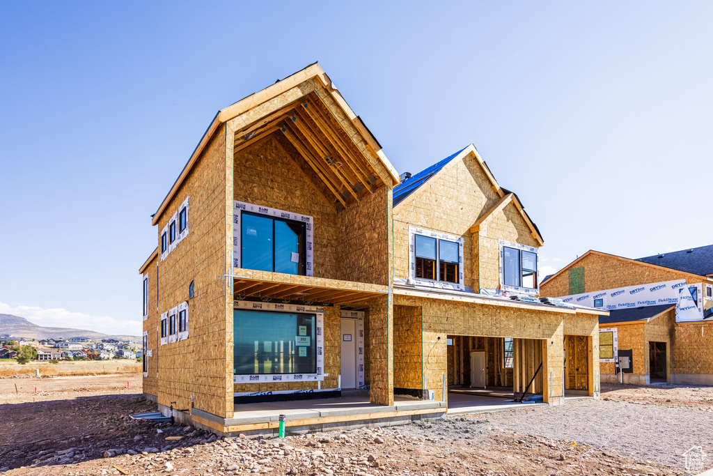 Rear view of house featuring a mountain view