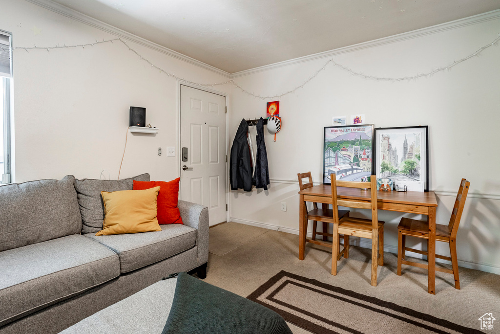 Living room with ornamental molding and carpet