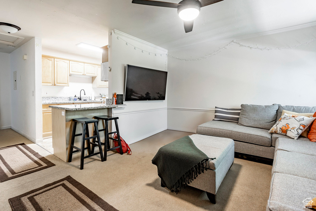Living room with light carpet, sink, and ceiling fan