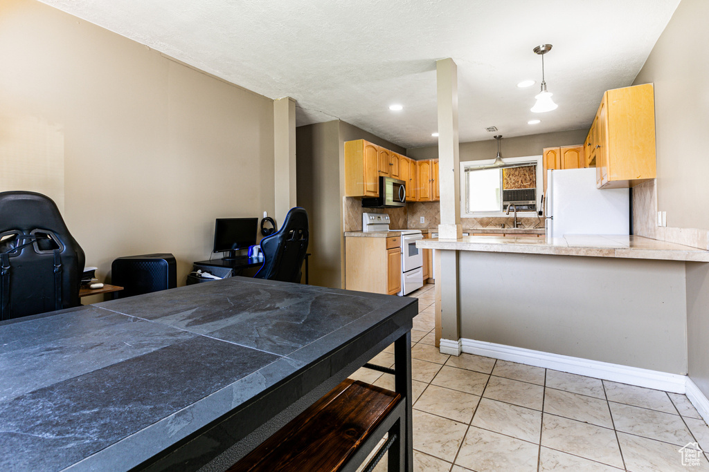 Tiled dining space featuring sink