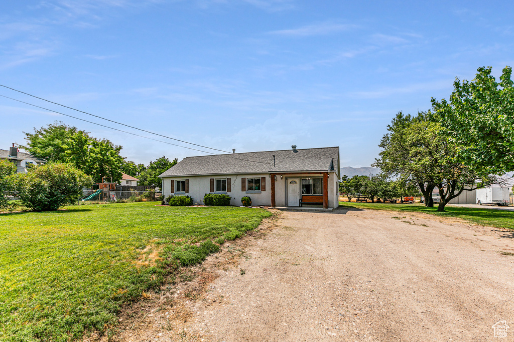 Ranch-style house with a front yard and a playground